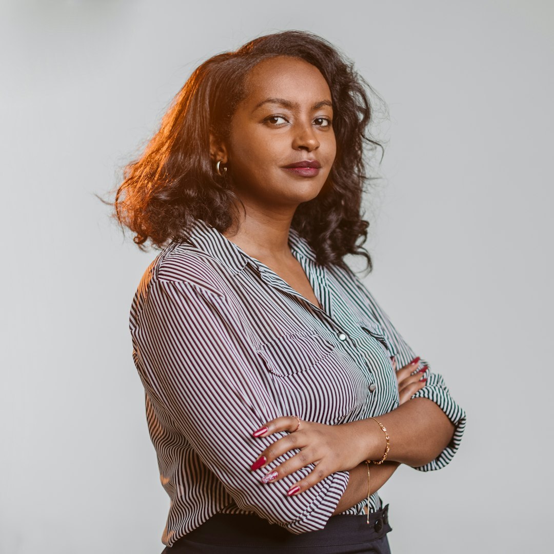 Professional portrait of a woman in her 30s with brown hair and blazer